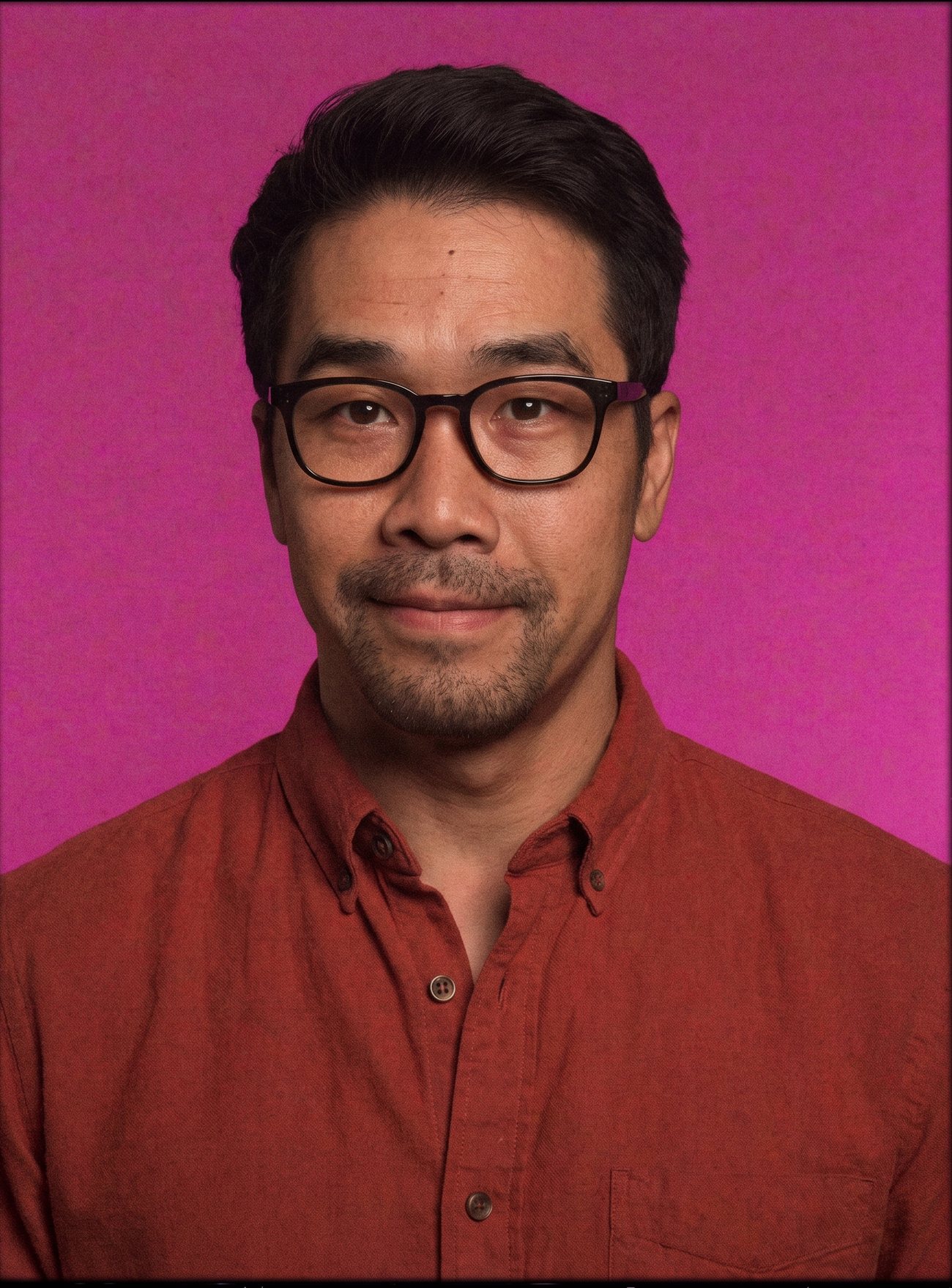 Portrait of Ly against a pink wall