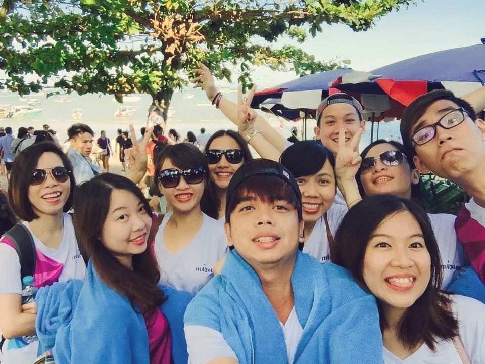 Team selfie under a beach tree